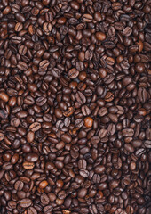 Fresh raw organic coffee beans top view background.