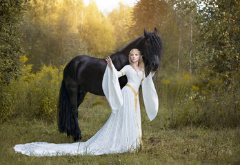 Elven story: blonde elf with a huge black stallion in a sunny forest - obrazy, fototapety, plakaty