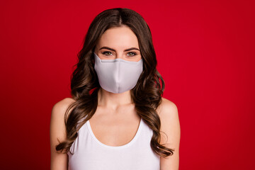 Close-up portrait of her she nice-looking attractive lovely charming wavy-haired girl wear medical mask in covid quarantine isolated over vivid vibrant red color background