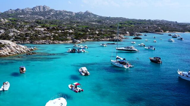 Flying Low over Boats and Luxury Yachts at Caprera Island Bay in Sardinia. Caribbean Water. Cala Serena. Famous Travel Destination. Sardegna, Italy.