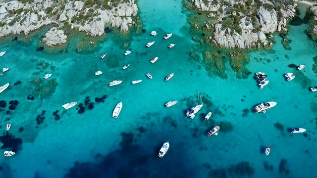 Top Down Aerial Drone View of Caprera Island, Sardinia, Italy.
Bay Full of Boats. Caribbean Cristal Clear Water. Famous Holiday Destination. Bird Eye View over Colorful Turquoise Sea.