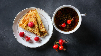 Pancakes with raspberry and rose hip tea
