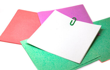 Blank with a white sheet on a colored background, office supplies on a table with paper clips