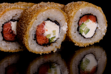 Fresh delicious beautiful sushi rolls on a dark background