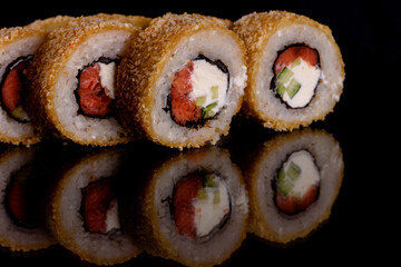 Fresh delicious beautiful sushi rolls on a dark background