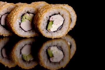 Fresh delicious beautiful sushi rolls on a dark background