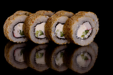 Fresh delicious beautiful sushi rolls on a dark background
