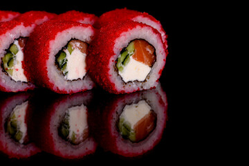 Fresh delicious beautiful sushi rolls on a dark background