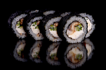 Fresh delicious beautiful sushi rolls on a dark background