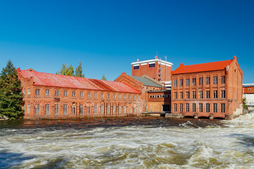 Kouvola, Finland - 15 September 2020: Old red brick buildings of Upm factory on rapids Kuusankoski.