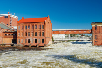 Kouvola, Finland - 15 September 2020: Old red brick buildings of Upm factory on rapids Kuusankoski.