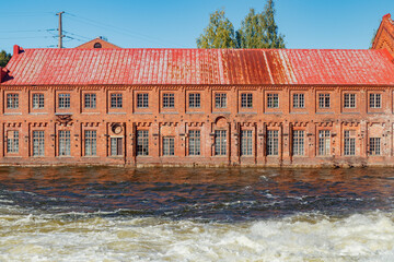 Kouvola, Finland - 15 September 2020: Old red brick buildings of Upm factory on rapids Kuusankoski.