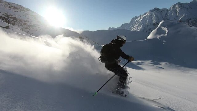 Professional freeriding in untracked deepsnow. Unbelievable mountain view high up in the tyrolean mountains. Very steady action freeriding slomotion. Sixty frames per second.