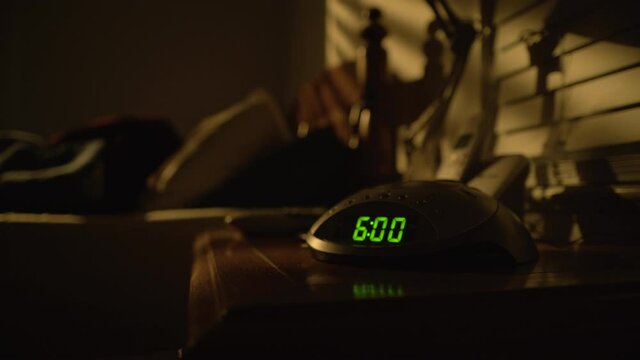 Tired Woman Turns off Alarm Clock at 6 AM and Rolls Out of Bed, Static