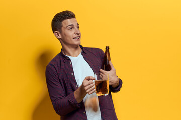 cheerful man mug of beer with bottle fun drunken lifestyle alcoholic yellow background