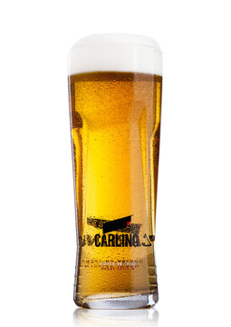 LONDON, UK - MAY 29, 2017: Cold Glass of Carling lager beer on white. With foam and dew.