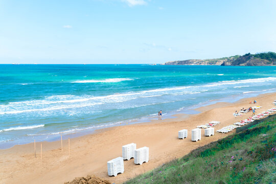 Sandy beach and sea against blue sky in Kilyos, cliffs at the far end, Black Sea Region in İstanbul