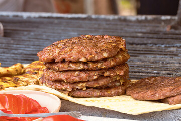 Traditional serbian street food (rostilj) - pljeskavica, cevapi, grilled chicken breast, bbq chicken wings and homemade sausages served with fresh bakery (lepinja)