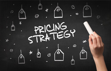 Hand drawing PRICING STRATEGY inscription with white chalk on blackboard, online shopping concept