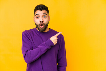 Young mixed race arabic man isolated pointing to the side