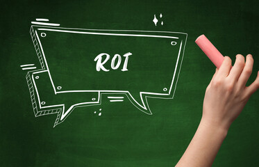 Hand drawing ROI abbreviation with white chalk on blackboard