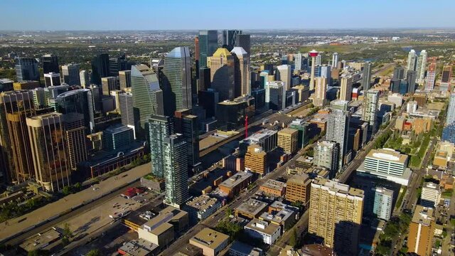 Aerial view overlooking buildings in the Calgary design district, during golden hour, in Alberta, Canada - Orbit, drone shot
