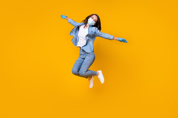 Plakat Full length body size view of her she nice attractive careless active girl wearing safety gauze mask jumping having fun disease prevention isolated bright vivid shine vibrant yellow color background