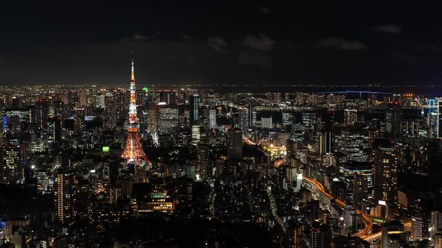 Beautiful panoramic Timelapse of Tokyo night cityscape with Tokyo Tower illuminations and traffic - Zoom In