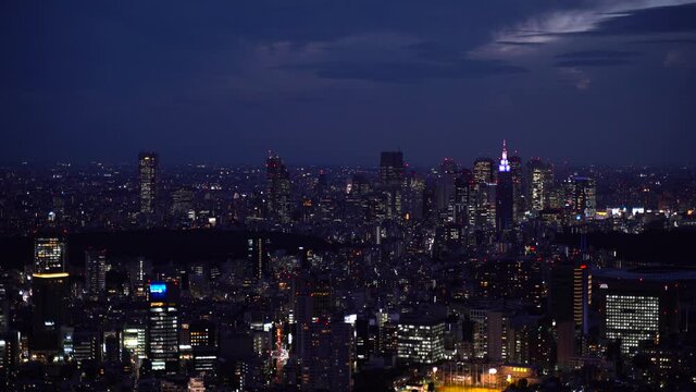 High above panoramic view out on Shinjuku, Tokyo skyline at night in 4k