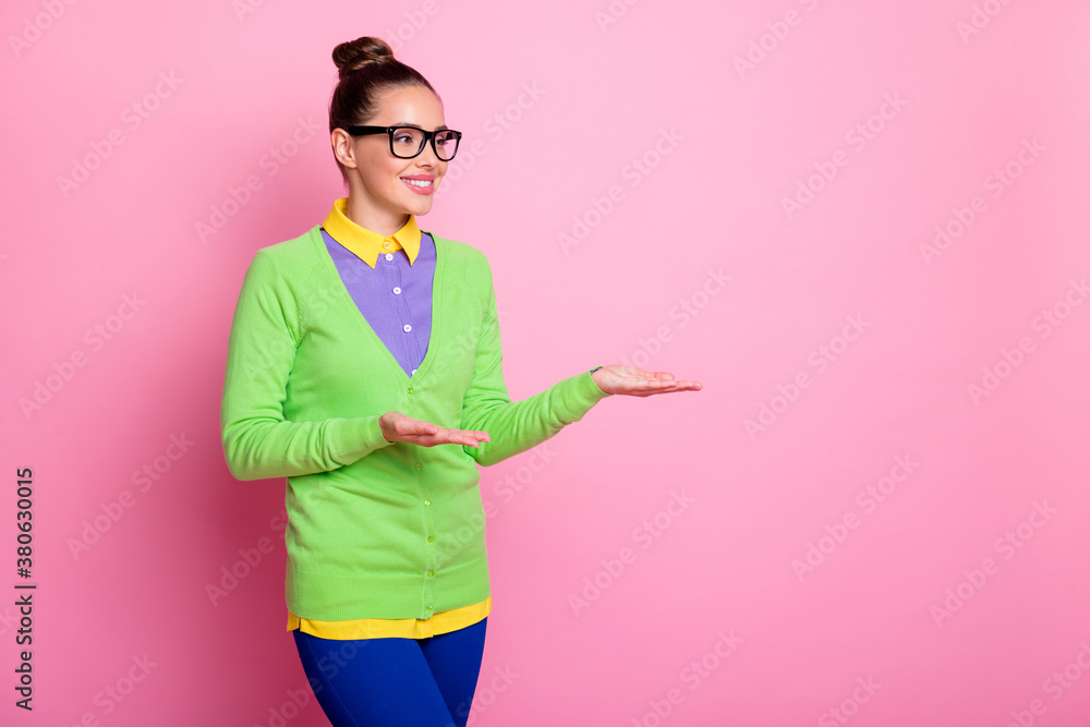 Poster Photo of charming lovely promoter girl knot hairstyle palms hold empty space presenting promotion sale shop mall boutique wear spectacles colored clothes bright pink color background