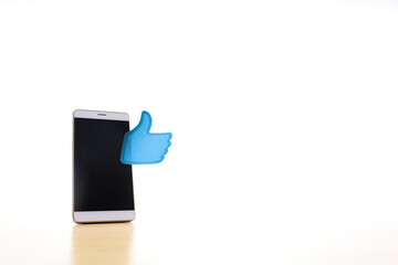 A smartphone with a thumb up sign on white background 