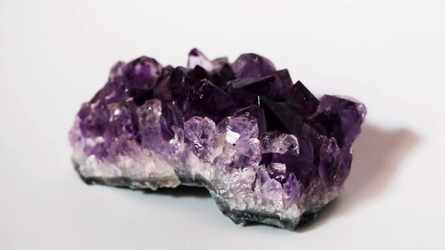Still shot of Purple Amethyst druse crystal in white background