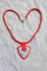 Red and turquoise pendant in boho style. Handmade jewelry design.