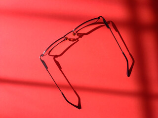 Modern eyeglasses lie on the table top view