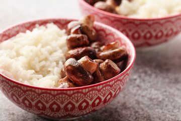 Rice with mushrooms. Traditional Chinese food. Chinese rice with chopsticks. Chinese cuisine in a pink bowl