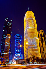 Futuristic modern architecture and offices in the Diplomatic area of Doha illuminated at night
