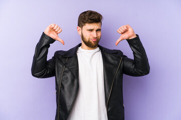 Young man isolated on purple background feels proud and self confident, example to follow.