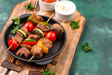 Grilled kebabs with meat, mushrooms and vegetables
