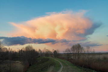 red cloud cloud over the forest by the lake at sunset