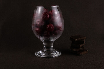 Crystal glass with frozen cherries and chocolate