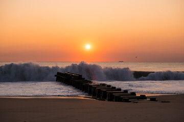 A beautiful sunrise on the last day of Summer at Rehobeth Beach in Delaware. A freight carrying...