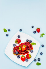 Cottage cheese pancakes with fresh berries and strawberry sauce. Healthy breakfast concept for kids