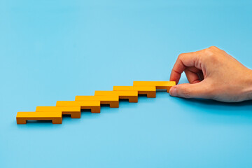 Business concept for growth success process, hand stacking wood
