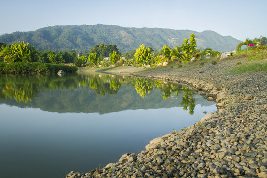water reflection lake tropical landscape of trees and mountain in dominican republic
