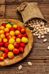 Harvest ripe cherry plum with seeds on wooden background