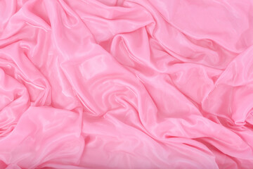 Obraz premium The pink silk fabric lies in folds in the water.