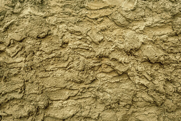 Liquid dirt, wet mud texture and background. wet clay top view. covering the wall with brown textured clay.