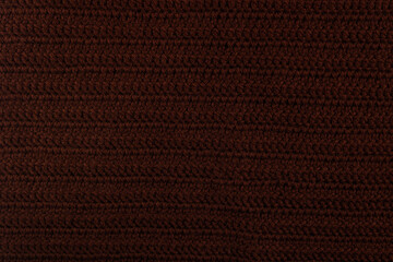 The background is knitted in brown yarn