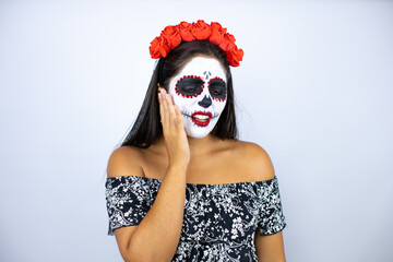 Woman wearing day of the dead costume over isolated white background touching mouth with hand with painful expression because of toothache or dental illness on teeth