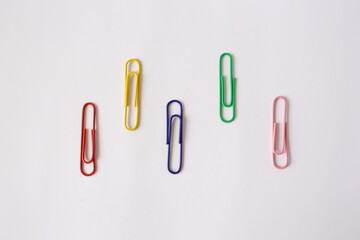 Colored paper clips close-up on a white background
